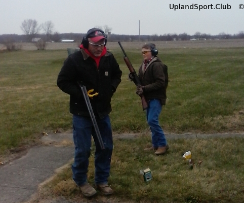 Father and son prepare for warm up shoot on a cool day